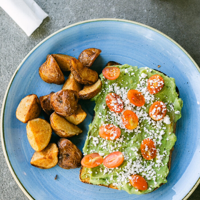 "Avocado toast served with roasted potatoes" title="Fresh avocado toast with crispy roasted potatoes" />